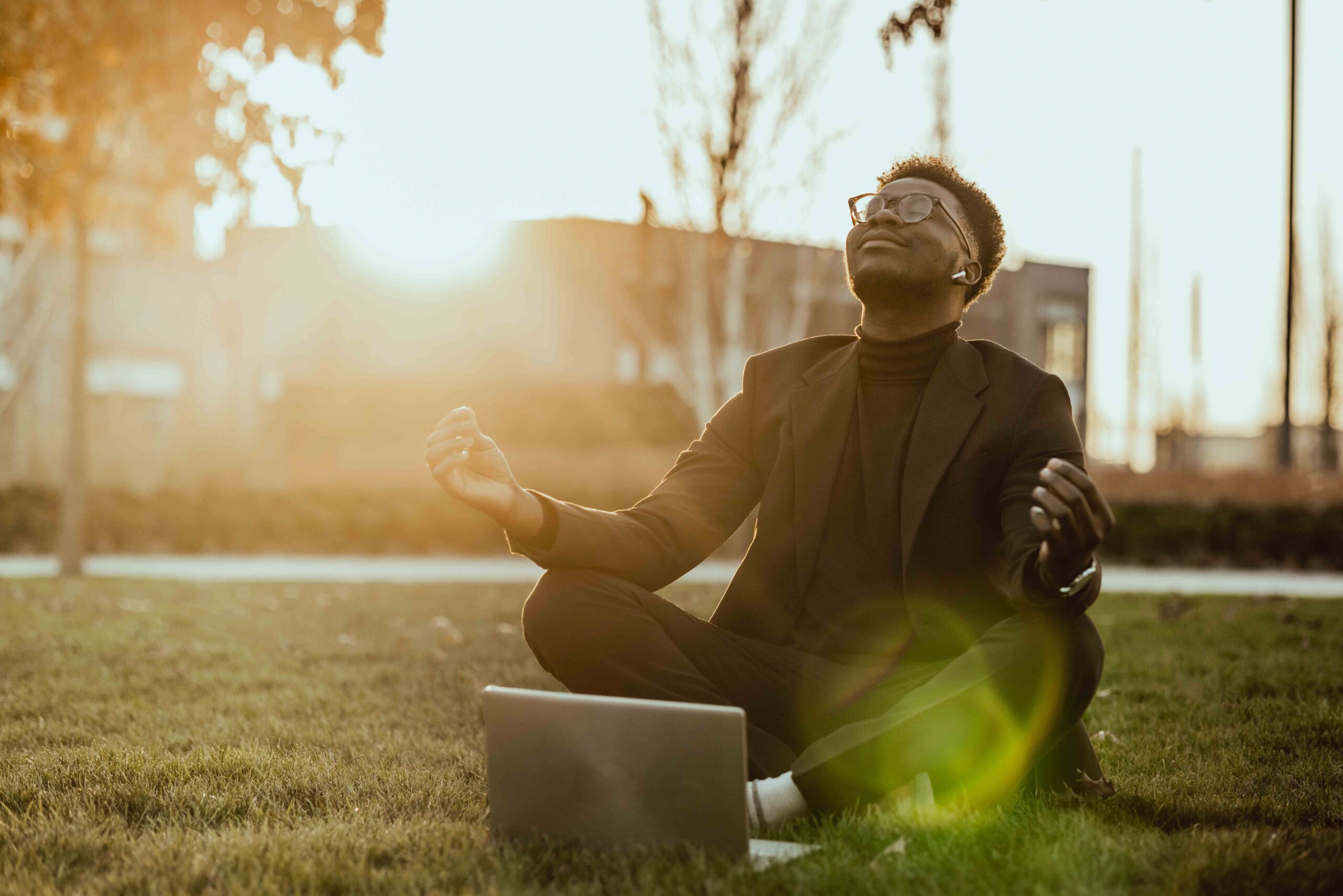Businessman exercising Yoga at sunset